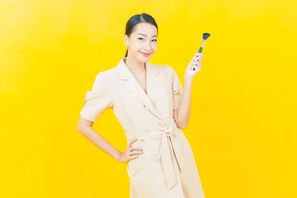 Renk Arka Planında Makyaj Fırçası Olan Güzel Asyalı Kadın Portresi — Stok fotoğraf