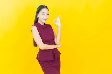 Portre güzel Asyalı kadın gülümsüyor. Renkli arka planda hareket var.