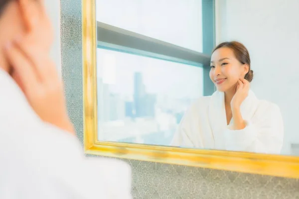 在浴室的镜子前 年轻美丽的亚裔女子在镜子前检查自己的脸 — 图库照片