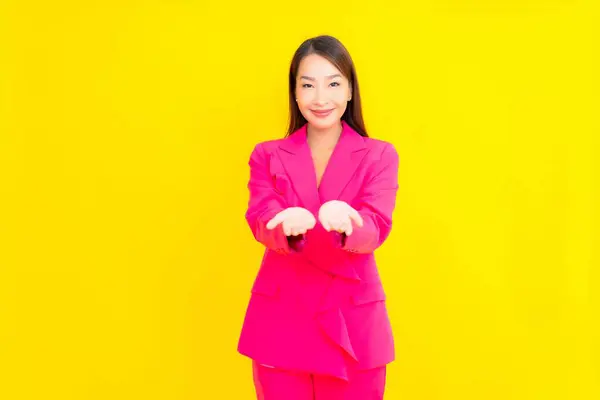 stock image Portrait beautiful young asian woman smile in action on yellow color background