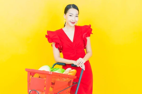 Renkli Arka Planda Süpermarketten Alınmış Market Sepetiyle Gülümseyen Güzel Asyalı — Stok fotoğraf