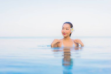 Güzel bir Asyalı kadın portresi. Rahat ol. Yüzme havuzu etrafında gülümse.