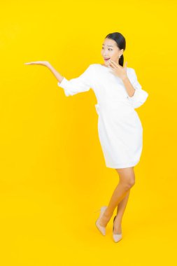 Portre güzel Asyalı kadın gülümsüyor. Renkli arka planda hareket var.