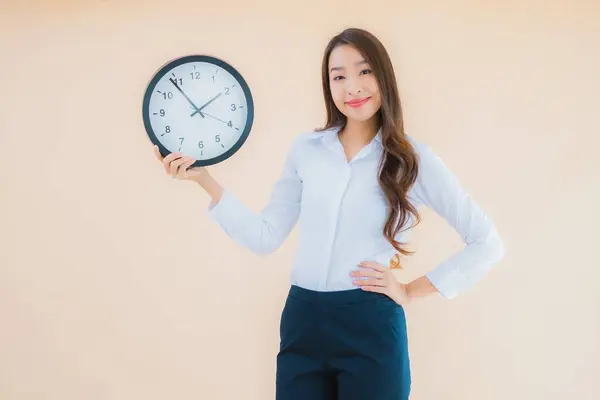 Porträt Schöne Junge Asiatische Frau Zeigen Wecker Oder Uhr Auf lizenzfreie Stockfotos