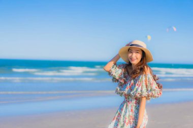 Güzel bir Asyalı kadın portresi. Mutlu bir gülümseme. Mavi gökyüzündeki tropikal deniz okyanusunda rahatla.