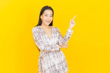 Portre güzel Asyalı kadın gülümsüyor. Renkli arka planda hareket var.