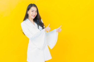 Portre güzel Asyalı kadın gülümsüyor. Renkli arka planda hareket var.