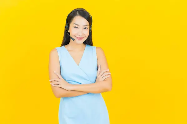 stock image Portrait beautiful young asian woman with call center customer care service center on yellow color background