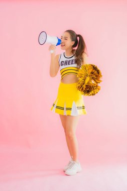 Pembe izole edilmiş arka planda megafonu olan güzel Asyalı amigo kız portresi.