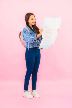 Portrait beautiful young asian woman backpack or luggage with camera ready for travel in vacation on pink background