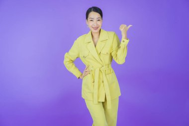 Portre güzel Asyalı kadın gülümsüyor. Renkli arka planda hareket var.