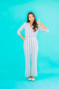 Asyalı güzel bir kadının portresi mavi izole edilmiş arka planda gülümsüyor.