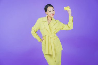 Güzel bir Asyalı kadının portresi. Renkli kredi kartıyla gülüyor.