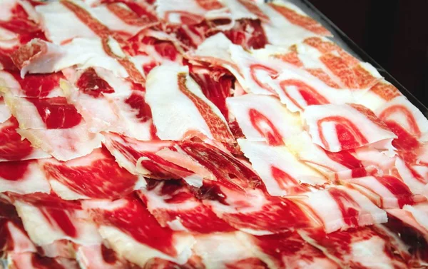 Stock image A plate of jamon serrano, cured Spanish ham cut in thin slices on a tray