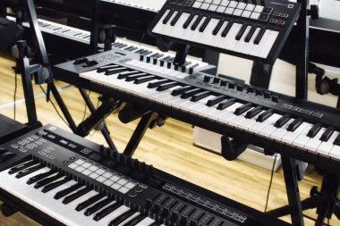 A collection of several digital MIDI keyboards with knobs, buttons and faders clipart