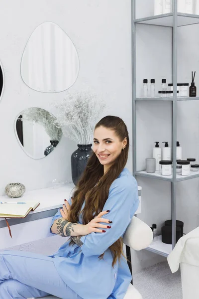 The cosmetic dermatologist\'s work desk is surrounded by carefully chosen accessories, plants, and books, creating a relaxing and personalized environment for her patients.
