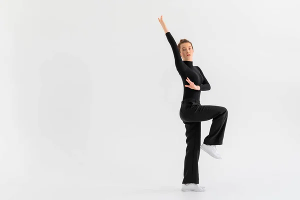 stock image Young Girl, professional hip-hop dancer in a black clothes performing over a Isolated white background with a plenty of copy space.