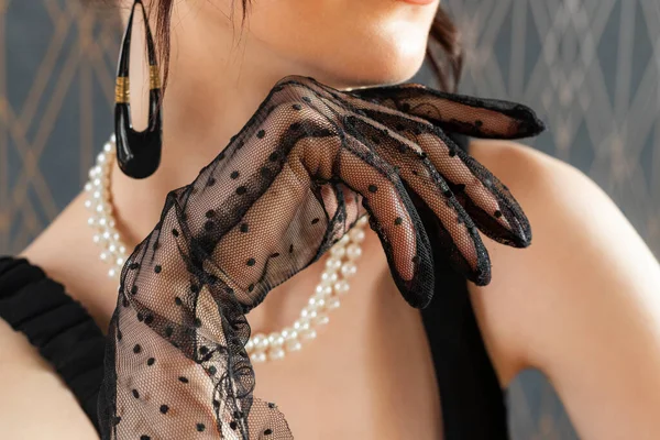 Close-up of an arm in Mesh Sheer glove of an elegant girl. Concept of elegance and sophistication. Formal or upscale event.
