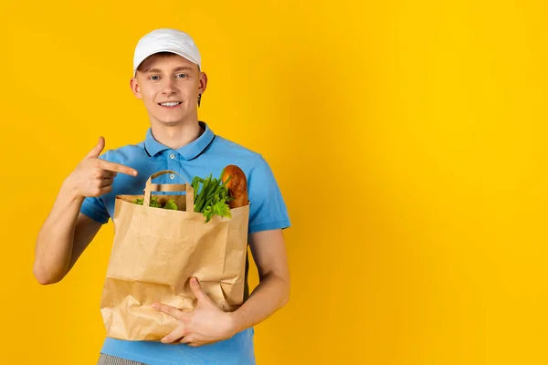 Young Man Blue Shirt Cap Holds Paper Bag Food Isolated — Stock Photo, Image
