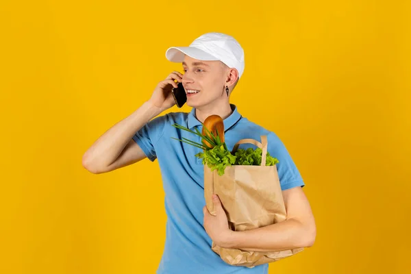 Young Man Blue Shirt Cap Holds Paper Bag Food Isolated — Stock Photo, Image
