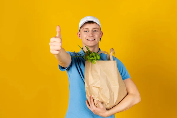 Young Man Blue Shirt Cap Holds Paper Bag Food Isolated — Stock Photo, Image