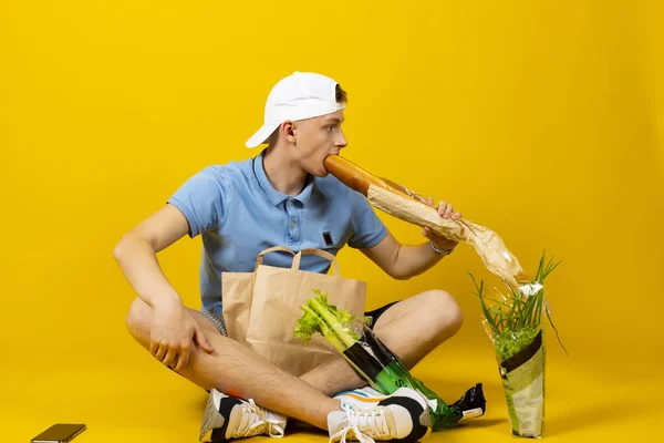 Delivery Man Blue Shirt Cap Sitting Floor Paper Bag Full — Stock Photo, Image