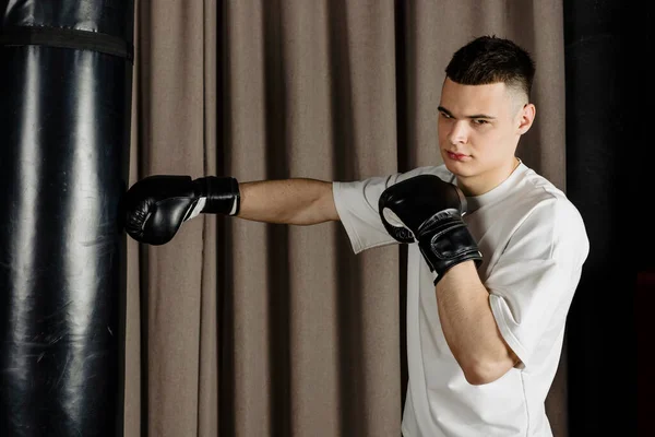 Boxer Training Punching Bag Cozy Beige Studio Throwing Punch — Stock Photo, Image