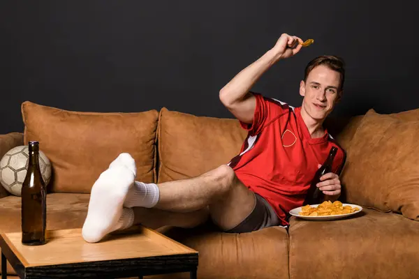 Football Fan Red Jersey Watching Match Lying Couch Drinking Beer — Stock Photo, Image
