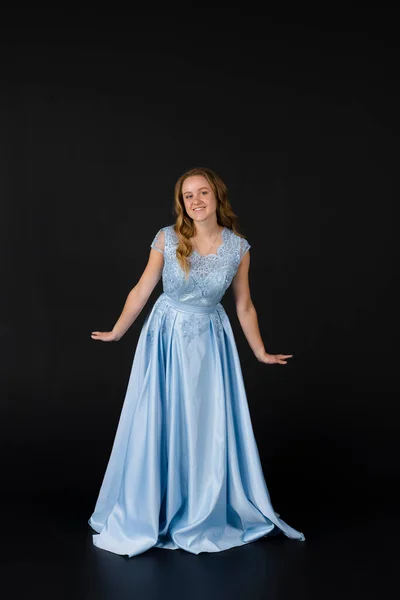 stock image Beautiful young Bridesmaid in blue dress, posing. isolated on black background.