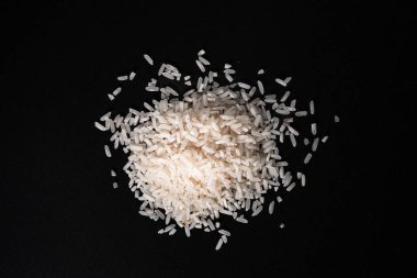 Çiğ pirinç tanelerini kapatın. Gıda blogları, mutfak içeriği, tarımsal görseller, malzeme katalogları veya temel gıdalarla ilgili ambalaj tasarımı için ideal