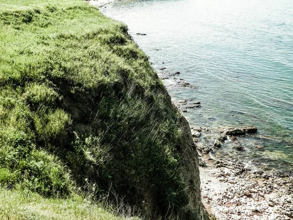 stock image Green grass on cliffs on the Black Sea coast. Landscape of cliffs and beach in Vama Veche, Dobrogea region, Romania. Nature and traveling concept.