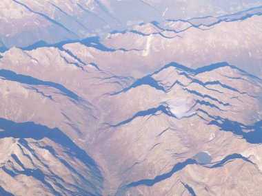 Alpler, uçağın penceresinden dağların manzarası. Toprak bükme ve doğa kavramı.