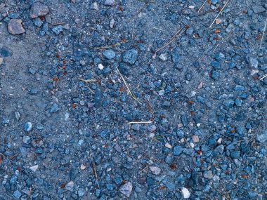 Ground and stones as a natural background. Copy space. Abstract art filter.