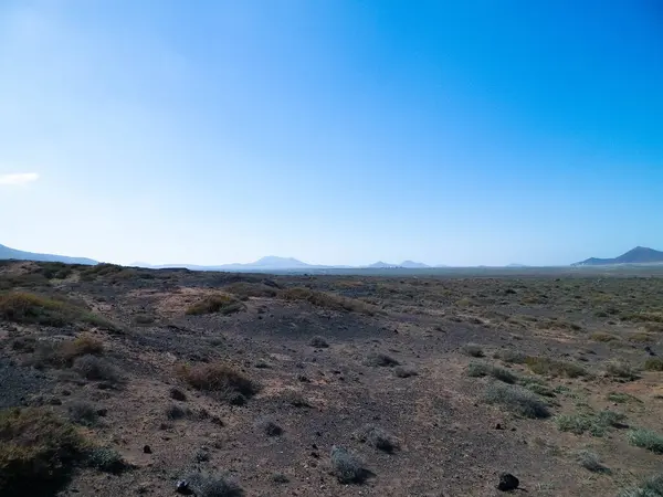 stock image Desert landscape, Lanzarotte , Canary Islands. Desert is typical landscape on Lanzarote island. Travel and nature concept.