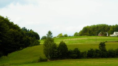 Green hills and forest - landscape of Kashubian Region, Poland. Travel and nature concept.