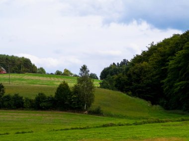 Green hills and forest - landscape of Kashubian Region, Poland. Travel and nature concept.