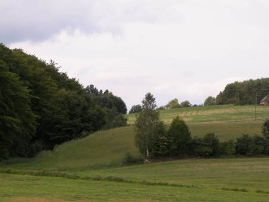 Green hills and forest - landscape of Kashubian Region, Poland. Travel and nature concept.