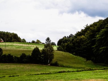 Green hills and forest - landscape of Kashubian Region, Poland. Travel and nature concept.