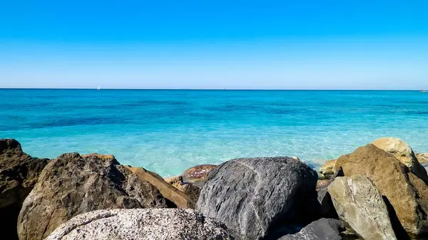 stock image Stones on the beach in Vada, transparent, turquoise water and white sand. Travel and nature concept.