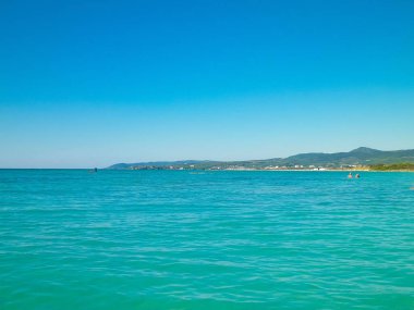 Sahil ve şeffaf, Tiren Denizi 'nin turkuaz suyu. Seyahat ve doğa kavramı. Güneşli bir yaz günü. Boşluğu kopyala.