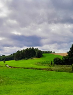 Storm is coming. Cloudy sky over Kashubian meadows. Pure nature, beautiful landscape of northern Poland. Kashyubia Region in Pomerania. clipart