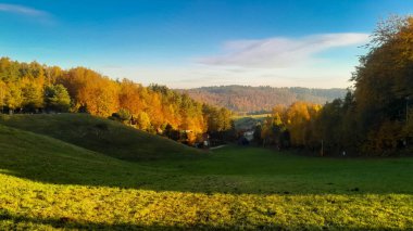 Green fields, hills and meadows. Landscape of Wiezyca region in Kashubia northern Poland in autumn. clipart