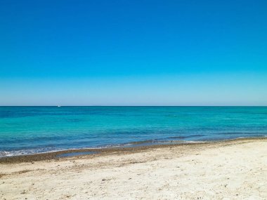 Sandy beach in Vada, transparent, turquoise water and white sand. Travel and nature concept. clipart