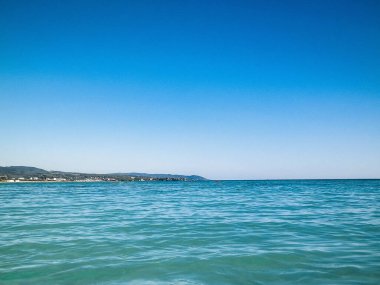 Sahil ve şeffaf, Tiren Denizi 'nin turkuaz suyu. Seyahat ve doğa kavramı. Güneşli bir yaz günü. Boşluğu kopyala.