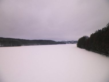 Frozen Ostrzyckie lake in Wiezyca. Winter nature concept. Kashubia northern Poland. clipart