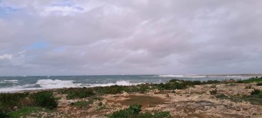 Stormy weather in Saint Paul's Bay. Malta after season. Storm on Mediterranean sea. clipart