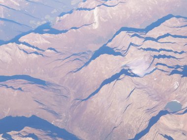 Alpler, uçağın penceresinden dağların manzarası. Toprak bükme ve doğa kavramı.