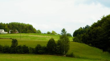 Green hills and forest - landscape of Kashubian Region, Poland. Travel and nature concept.