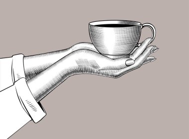 Kadın eli, kahve fincanını eski gravür tarzında tutuyor.