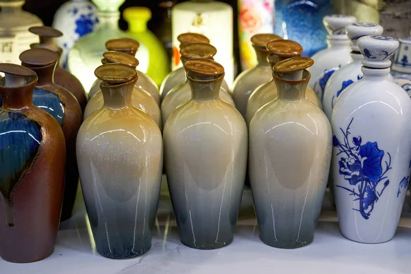 stock image Pile of assorted brand new ceramic wine bottles